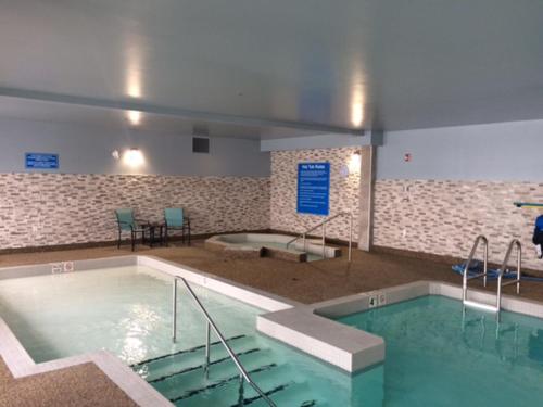 a swimming pool in a building with a swimming pool at Days Inn by Wyndham Calgary North Balzac in Balzac