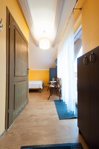 a room with a hallway with a door and a table at Willa pod Czantorią SPA Ustroń in Ustroń