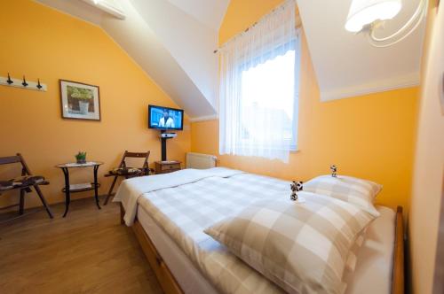 a bedroom with a large bed and a window at Willa pod Czantorią SPA Ustroń in Ustroń