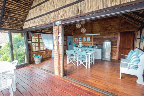 a large wooden deck with tables and chairs on it at Paradise Dunes in Praia do Tofo