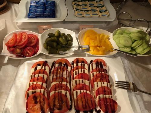 a table topped with plates of food and bowls of fruit at Hotel Garni Central - Zimmer - Studios - Apartments in Kappl