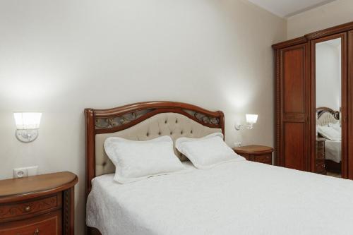 a bedroom with a bed with two white pillows at Arcadia VIP-apartments in Golfstream in Odesa