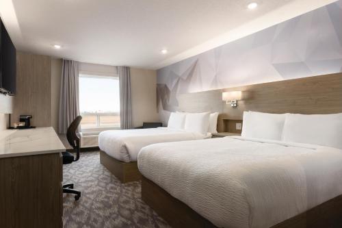 Postel nebo postele na pokoji v ubytování Days Inn by Wyndham Calgary North Balzac