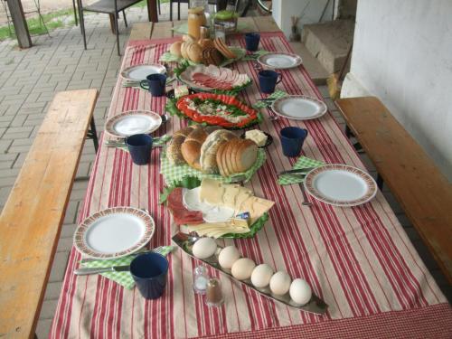 a long table with plates of food on it at Agroturystyka SZYSZKA in Polnica