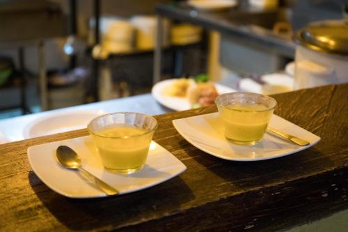 two glasses of orange juice on plates on a counter at La Tigra Rainforest Lodge in Fortuna