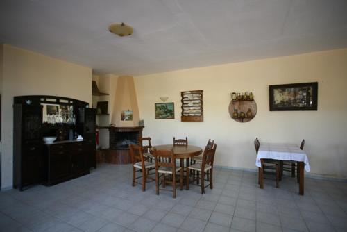 a kitchen and dining room with a table and chairs at Akti Damnoni in Damnoni