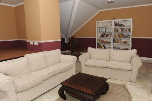 Sala de estar con 2 sofás blancos y mesa de centro en Villa Sobótka, en Sobótka