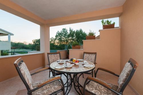 a patio with a table and chairs on a balcony at Apartments Karlo & Ivona in Labin