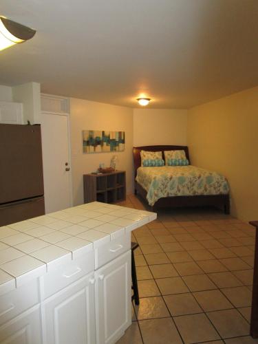 a bedroom with a bed and a table in it at Kauhale Makai Condo on the Beach in Kihei