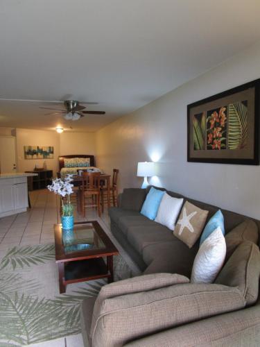 a living room with a couch and a table at Kauhale Makai Condo on the Beach in Kihei