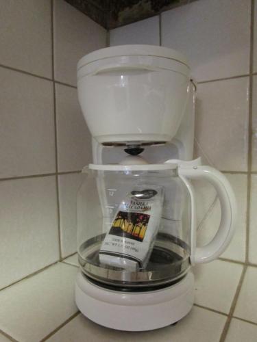 a white coffee cup sitting on top of a counter at Kauhale Makai Condo on the Beach in Kihei