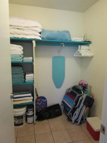 a room with a bunk bed and some clothes at Kauhale Makai Condo on the Beach in Kihei