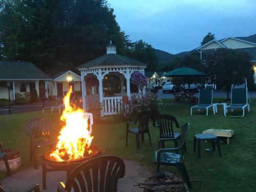 a fire pit in a yard with a gazebo at The Heritage of Lake George in Lake George