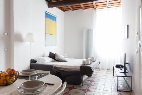 ローマにあるAlchimia Suite Trastevereのベッドルーム1室(ベッド1台、テーブル、プレート付)
