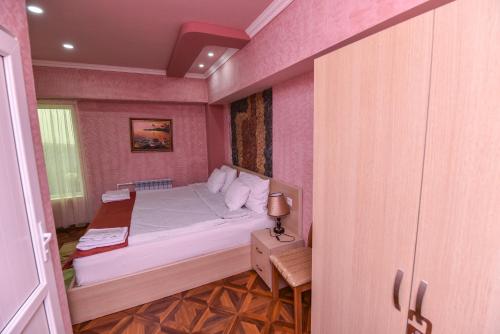 a small bedroom with a bed and a window at Gayane Hotel in Alaverdi