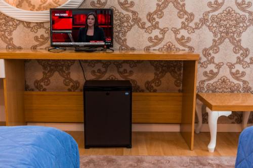 een televisie bovenop een tafel in een kamer bij Peracity Hotel in Ankara