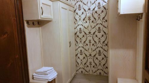 a bathroom with a shower and towels on a wall at Hotel Golden Spirit in Băile Herculane