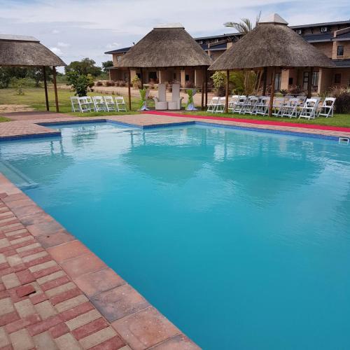 a large swimming pool with blue water in a resort at Hoyohoyo Acorns Lodge in Mission