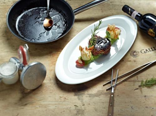a plate of food on a table with a pan at Hotel Gallia in Stelvio