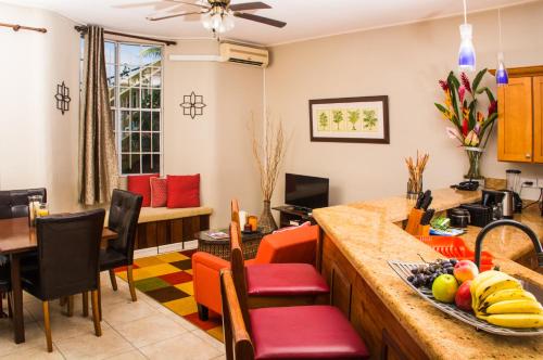 a kitchen and living room with a table and chairs at Heavenly Suites in La Feuillet