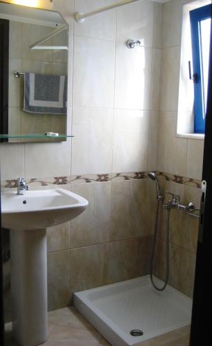 a bathroom with a sink and a shower at Yiorgos Studios in Palaiochora