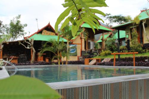 a swimming pool in front of a building at Black Lava Hostel and Lodge in Kintamani