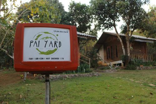a sign in a yard in front of a house at Pai Yard Guest House in Pai