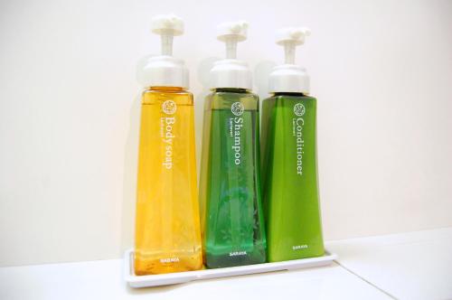 three green and yellow bottles sitting on a counter at Izumo Royal Hotel in Izumo