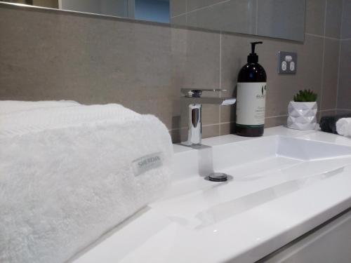 a white sink with a bottle of wine on it at East 34 in Ballarat