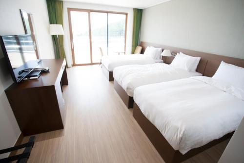 Ένα ή περισσότερα κρεβάτια σε δωμάτιο στο Dongwon Youthhostel