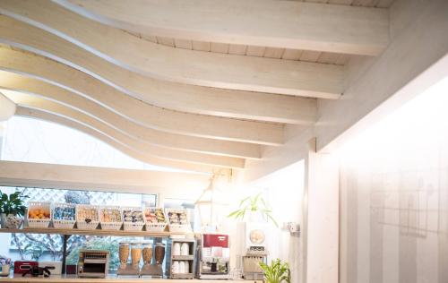 a room with a wooden ceiling in a store at Hotel Torino in Parma