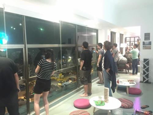 a group of people standing in a room looking at a display case at Space Cap Hotel in Kota Kinabalu