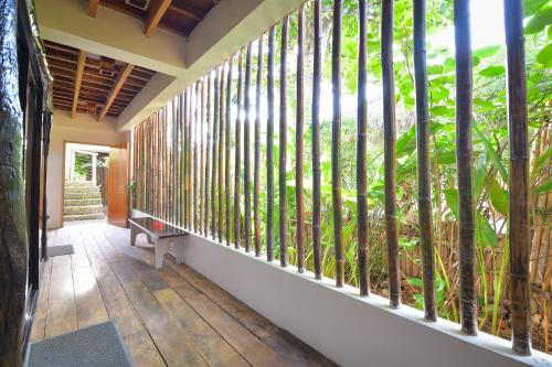 a corridor of a house with a balcony with trees at Diniview Villa Resort in Boracay