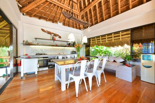 a kitchen and living room with a table and chairs at Diniview Villa Resort in Boracay