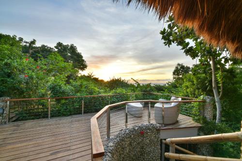 a wooden deck with a view of the trees at Diniview Villa Resort in Boracay