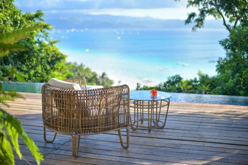 two chairs and a table on a wooden deck at Diniview Villa Resort in Boracay