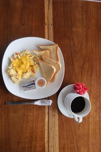 a plate of eggs and toast next to a cup of coffee at Hotel Caribbean View in Bastimentos