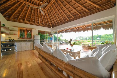 a living room with white chairs and a kitchen at Diniview Villa Resort in Boracay