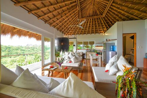 a living room with white couches and a kitchen at Diniview Villa Resort in Boracay