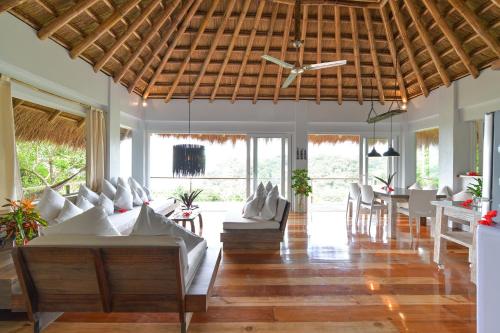 a living room with white furniture and a ceiling fan at Diniview Villa Resort in Boracay