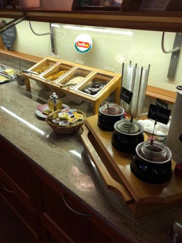 a kitchen counter with pots and pans on a counter top at Hotel Grimsel in Obergesteln