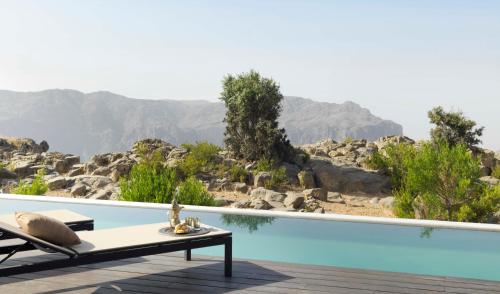 a swimming pool with a view of the mountains at Anantara Al Jabal Al Akhdar Resort in Al ‘Aqar