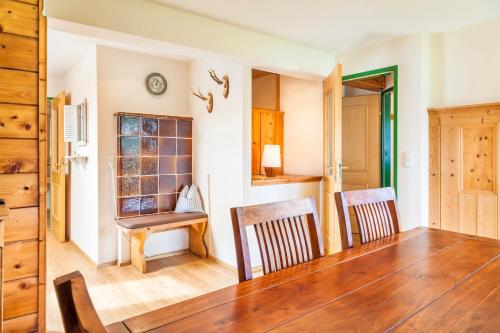a dining room with a table and two chairs at Wohlfühlbauernhof Bambichlhof in Fuschl am See