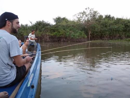 a group of people sitting in a boat fishing at ST 63 Home Stay & Tour Kampong Khleang in Kâmpóng Khleăng