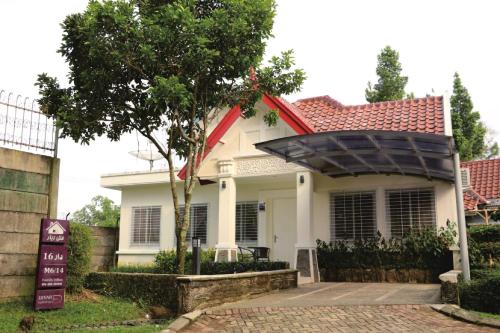 Casa blanca con techo rojo en Diyar Villas Puncak M6/14, en Puncak