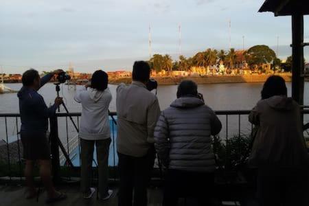 a group of people taking a picture of a river at ST 63 Home Stay & Tour Kampong Khleang in Kâmpóng Khleăng