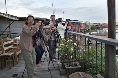 a group of people taking pictures with cameras at ST 63 Home Stay & Tour Kampong Khleang in Kâmpóng Khleăng