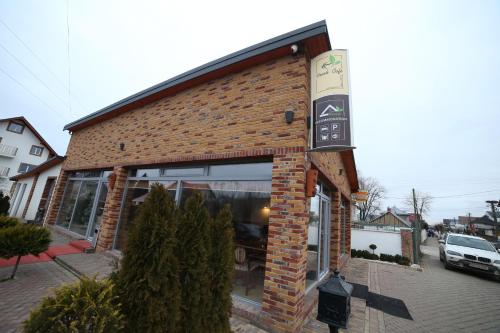 a brick building with a sign on the side of it at Fresh Accommodation in Rădăuţi