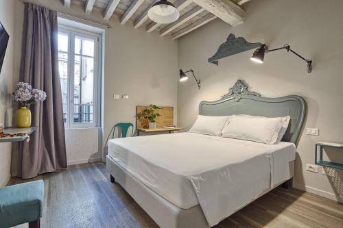 Tempat tidur dalam kamar di Hotel Torino