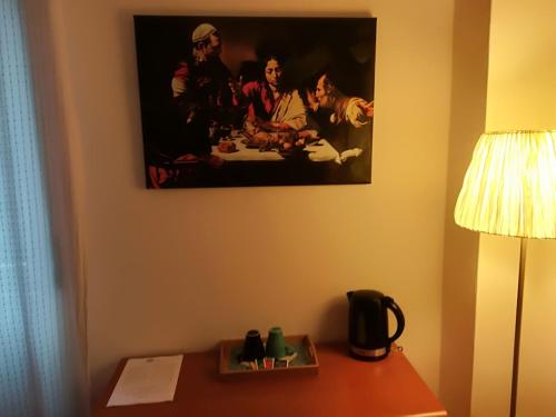 a painting on the wall of a hotel room at Luci A San Siro in Milan